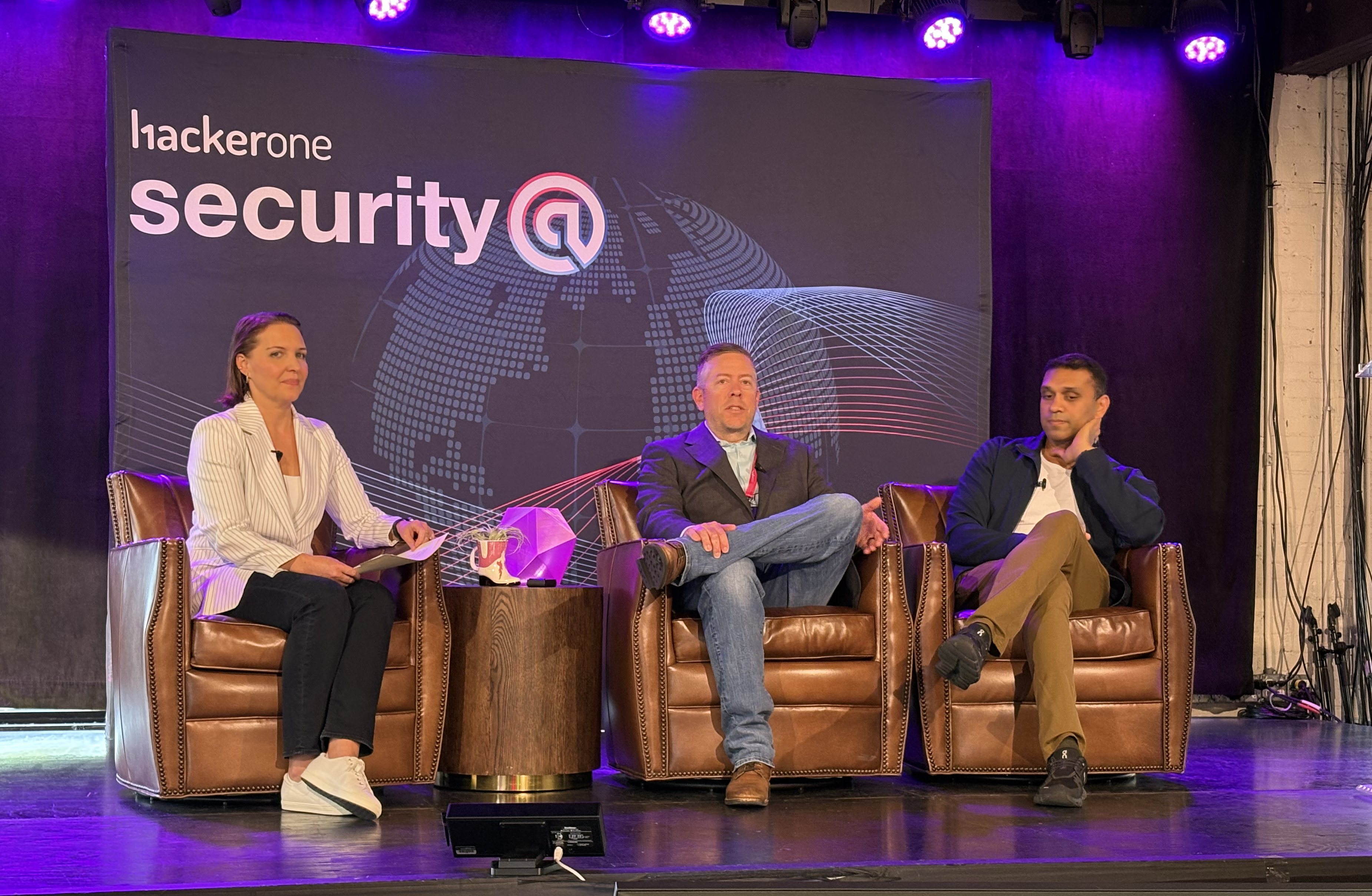 HackerOne’s Maggie Miller speaks with Alan Sebastian of CBRE (middle) and Benzi John of TikTok (right)